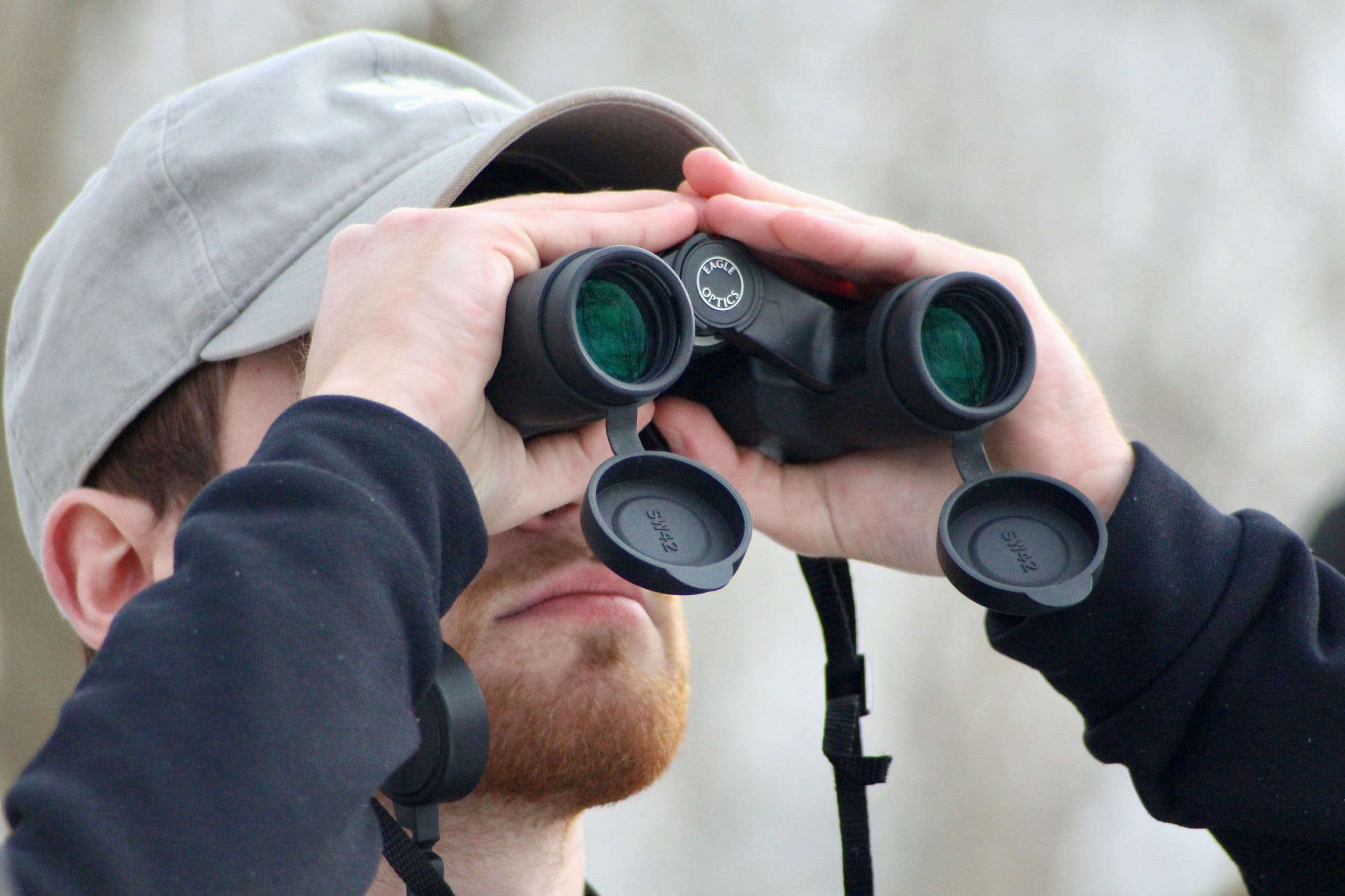 Mann mit Fernglas auf der Suche nach dem perfekten Match